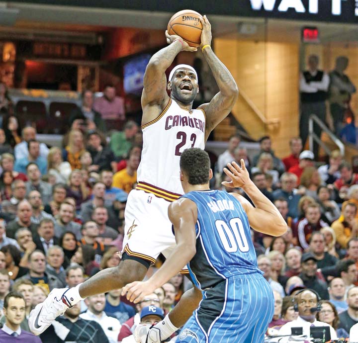 Cleveland Cavaliers’ Le Bron James shoots over Orlando Magics’ Aaron Gordon during their NBA match Tuesday in Cleveland where the Cavaliers superstar registered another milestone following their 117-103 win