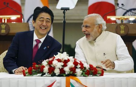 Japan's PM Abe and his Indian counterpart Modi shares a moment during a signing of agreement at Hyderabad House in New Delhi