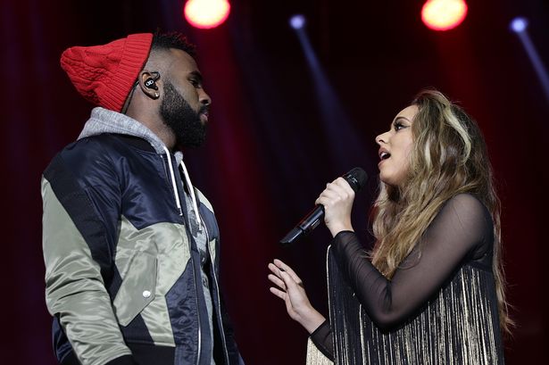 Jason Derulo and Jade Thirlwall from Little Mix performing on stage during the Capital FM Jingle Bell Ball 2015