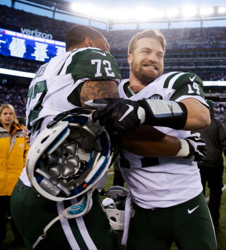 New York Jets quarterback Ryan Fitzpatrick celebrates with Stephen Bowen after overtime of an NFL football game against the New York Giants Sunday Dec. 6 2015 in East Rutherford N.J. The Jets won 23-20