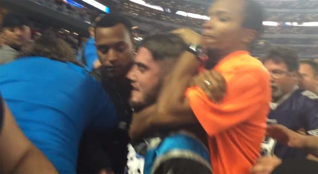 John Small gets put in a chokehold by stadium security during the Thanksgiving day game between the Cowboys and Panthers