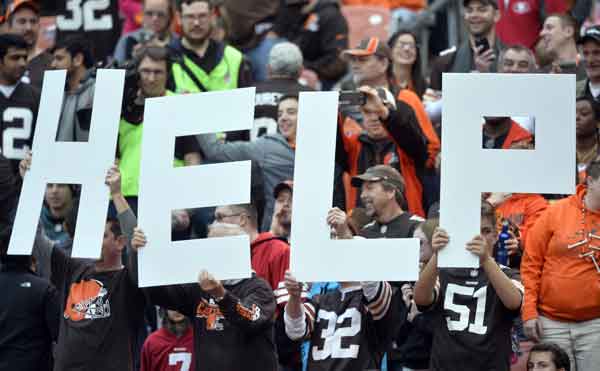 Cleveland Browns fans hold up a sign during the second half of an NFL football game between the San Francisco 49ers and the Cleveland Browns Sunday in Cleveland. AP