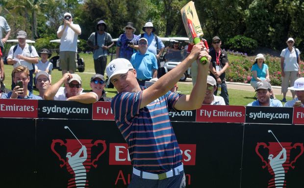 Jordan Spieth tries a cricket bat in Australia November 2015