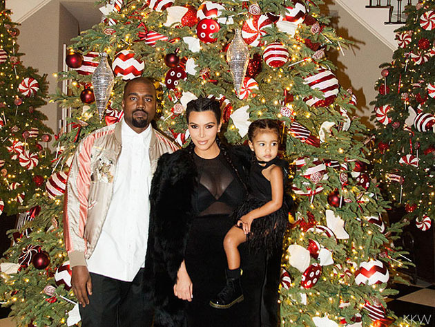 Kanye Kim and North in front of the Christmas tree