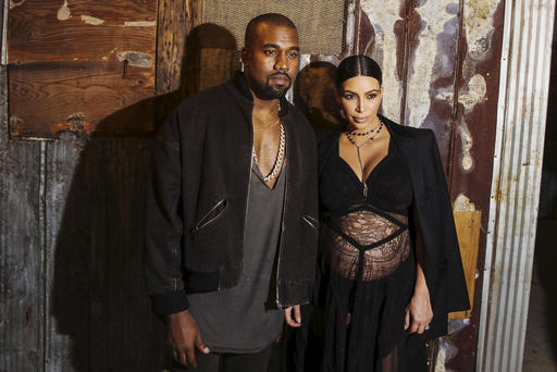 Musician Kanye West stands with his wife Kim Kardashian after watching the Givenchy Spring  Summer 2016 collection during New York Fashion Week Sep. 11 2015