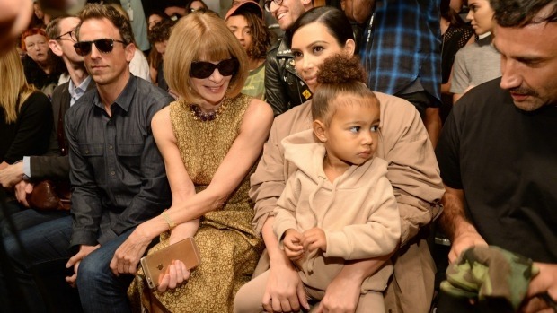 North West now aged two was kept away from paparazzi as a baby. Now she rubs shoulders with Vogue's Anna Wintour on the side of the runway