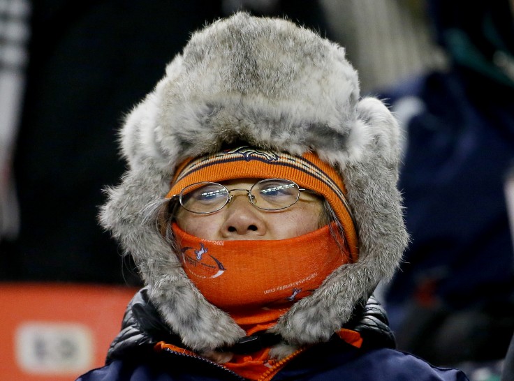 Keeping warm during the first half of the Broncos match against Cincinnati Bengals on Monday Dec. 28 2015 in Denver