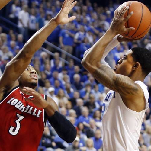 Ulis right shoots while defended by Louisville's Trey Lewis during the first half of an NCAA college basketball game Saturday Dec. 26 2015 in Lexington Ky