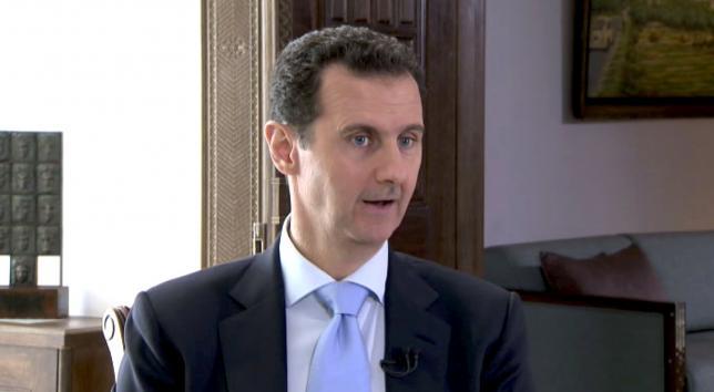 Syrian President Bashar al Assad speaks during a TV interview in Damascus Syria in this still image taken from a video