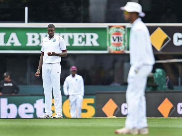 West Indies captain Jason Holder looks at the ball while bowling to Australia on the second day of the first cricket Test match in Hobart