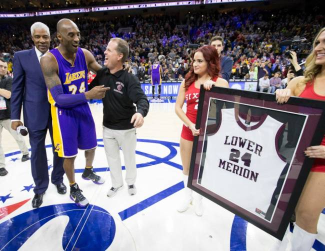 Former NBA player Julius Erving left and and Gregg Downer third from left present Los Angeles Lakers&#39 Kobe Bryant second left a framed Lower Merion jersey before an NBA basketball game against the Philadelphia 76ers Tuesday Dec. 1 2015 in Ph