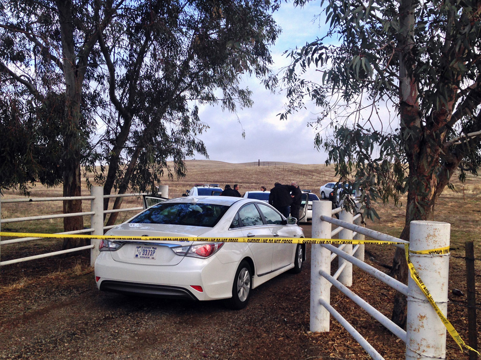 Kern County Sheriffs officials and deputies gather at the scene where a medical helicopter crashed near McFarland Calif. Friday Dec. 11 2015