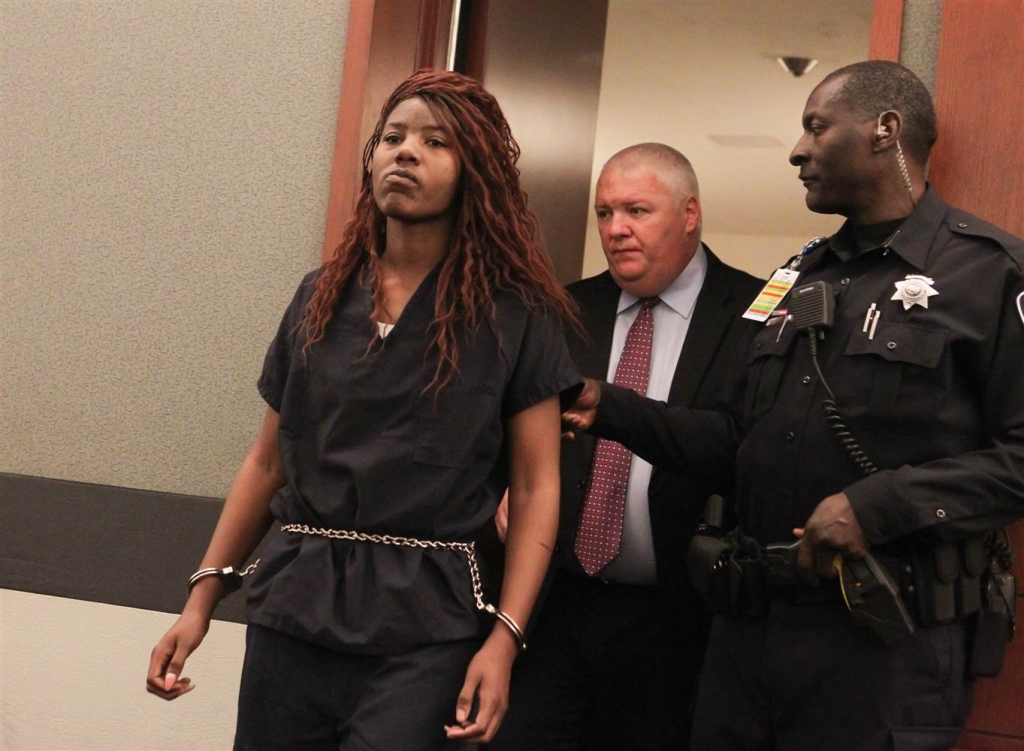 Lakeisha Nicole Holloway enters district court with one of her public defenders Scott Coffee for her arraignment on Dec. 23 2015 in Las Vegas