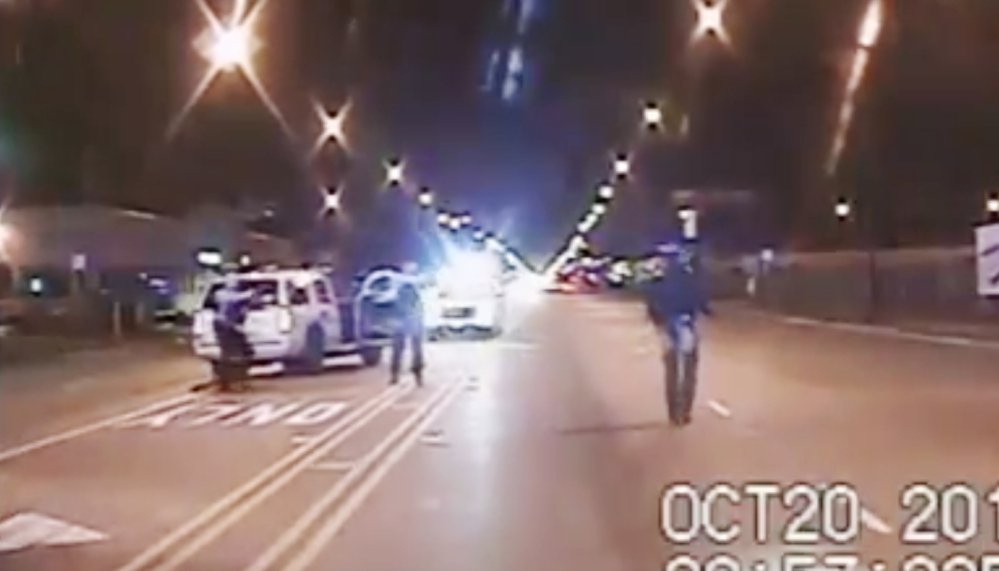 In this Oct. 20 2014 frame from dash-cam video Laquan McDonald right walks down the street moments before being shot by police officer Jason Van Dyke in Chicago