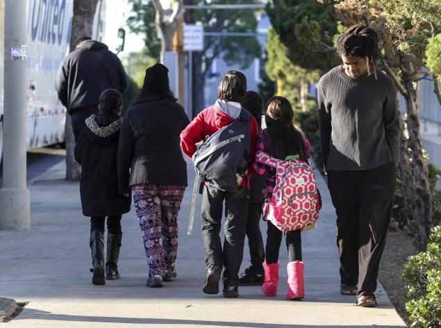 Parents with their children in Los Angeles Tuesday morning when the public school district was shut down over a phony email threat