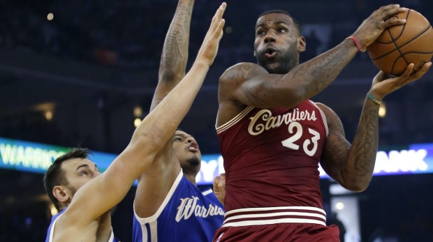 LeBron James drives to the basket next to Brandon Rush and Andrew Bogut