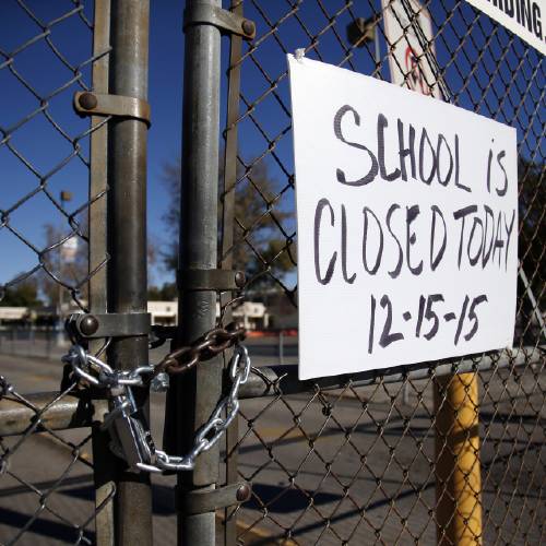 Birmingham Community Charter High School is locked with a sign stating that school is closed Tuesday Dec. 15 2015 in Van Nuys Calif. All schools in the vast Los Angeles Unified School District the nation's second largest have