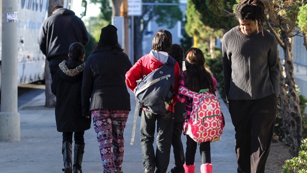 Parents take their children home from school early Tuesday in Los Angeles after all public schools in the city were ordered closed because of a violent threat emailed to several school board members