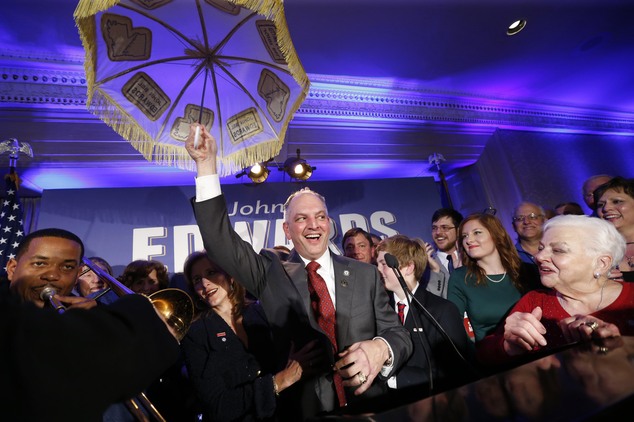 Louisiana Gov.-elect John Bel Edwards holds up an umbrella as he reacts with supporters at his election night watch party in New Orleans Saturday Nov. 21