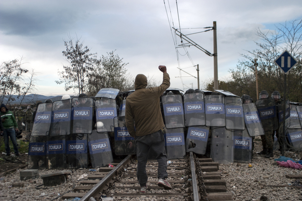 Macedonian police cordon during clashes with refugees protesting against the building of a metal fence at the Greek Macedonian border