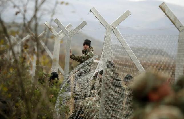 Macedonian soldiers erect a metal fence on the border with Greece near Gevgelija Macedonia