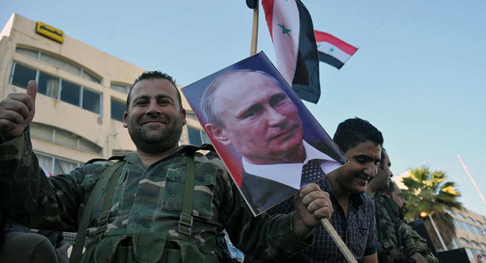 Syrian Arab Army troops take part in a rally in Tarus in support of the Russian Aerospace Force operation in Syria