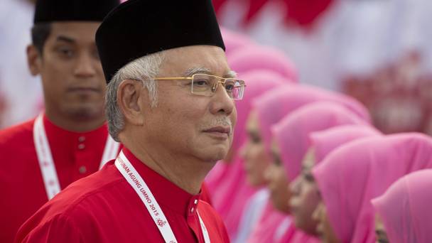 Malaysia's Prime Minister Najib Razak inspects a ceremonial guard of honour during the opening ceremony of the party's general assembly