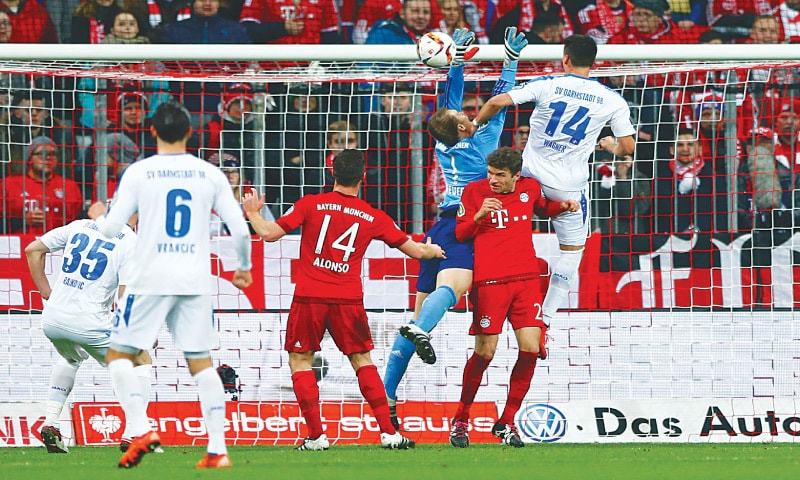 MUNICH Darmstadt 08’s Sandro Wagner vies for the ball with Bayern Munich goalkeeper Manuel Neuer during their German Cup last-16 match at the Allianz Arena.—AP