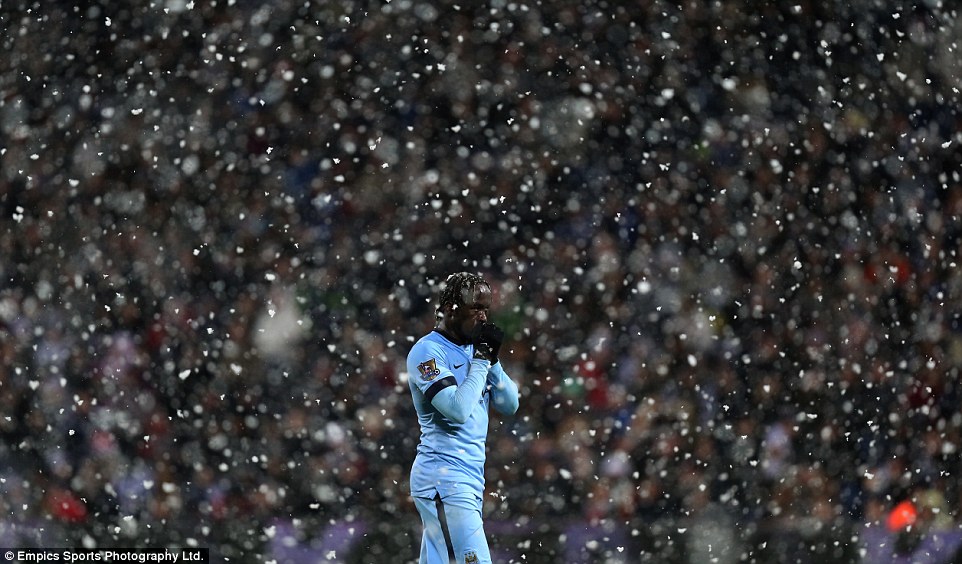 Manchester City defender Bacary Sagna braces the cold and the snow while in action at The Hawthorns on Boxing Day in 2014