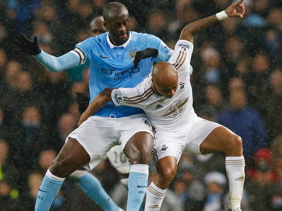 Manchester City's Yaya Toure in action with Swansea City's Andre Ayew