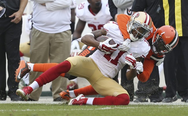 San Francisco 49ers wide receiver Quinton Patton is tackled by Cleveland Browns cornerback Charles Gaines after catching a pass during the second half of an NFL football game Sunday Dec. 13 2015 in Cleveland