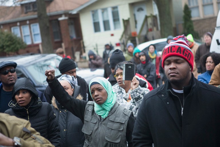 Family friends and supporters gather outside the home of Bettie Jones and Quintonio Le Grier during a vigil