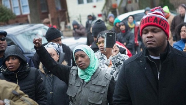 Family friends and supporters gather outside the home of Bettie Jones and Quintonio Le Grier during a vigil on Dec. 27 2015 in Chicago Illinois