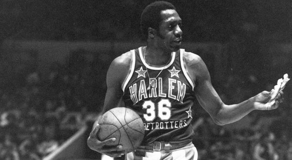 Meadowlark Lemon offers a pretzel to a referee during a Harlem Globetrotters game in 1978