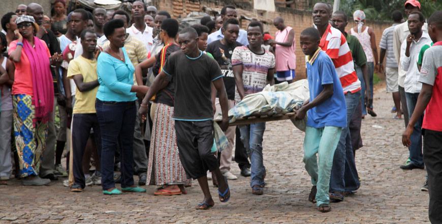 Men carry away a dead body in the Nyakabiga neighbourhood of Bujumbura on Saturday