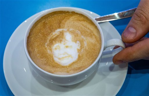 CDU federal chairwoman and Chancellor Angela Merkel has been etched into a cup of Cappuccino by a latte artist at the CDU federal party congress in Karlsruhe Germany. (Michael Kappel