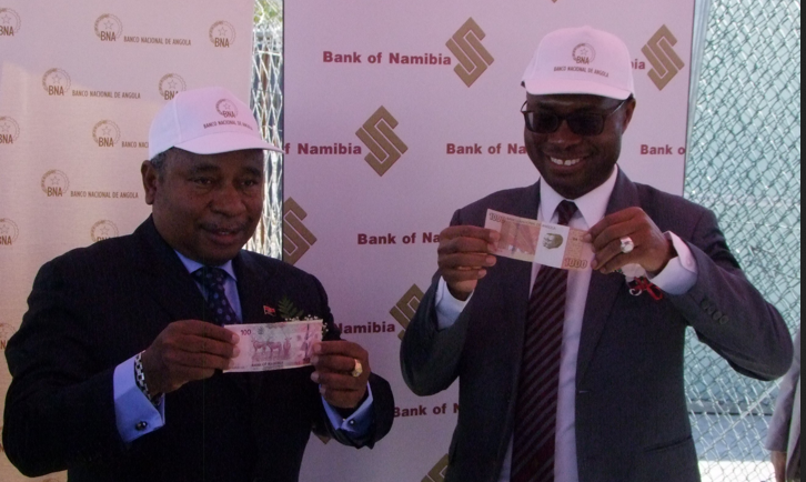 DEAL OFF... The Governor of Banco Nacional De Angola Jose Pedru De Morais and Governor of the Bank of Namibia Ipumbu Shiimi exchange currencies at the official commencement of the Namibian Dollar and Angolan Kwanza currency conversion agreement at