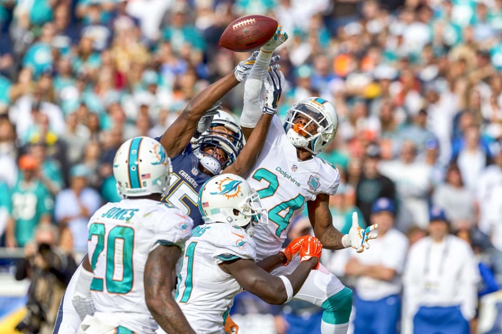 Miami Dolphins cornerback Brice Mc Cain deflects a pass intended for San Diego Chargers wide receiver Dontrelle Inman