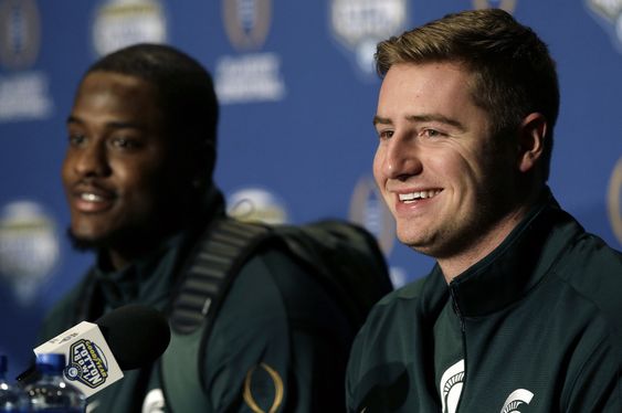 Connor Cook right smiles as he sits with teammate wide receiver Aaron Burbridge during a news conference for the NCAA Cotton Bowl college football game against Alabama Monday Dec. 28 2015 in Dallas. Cook says his