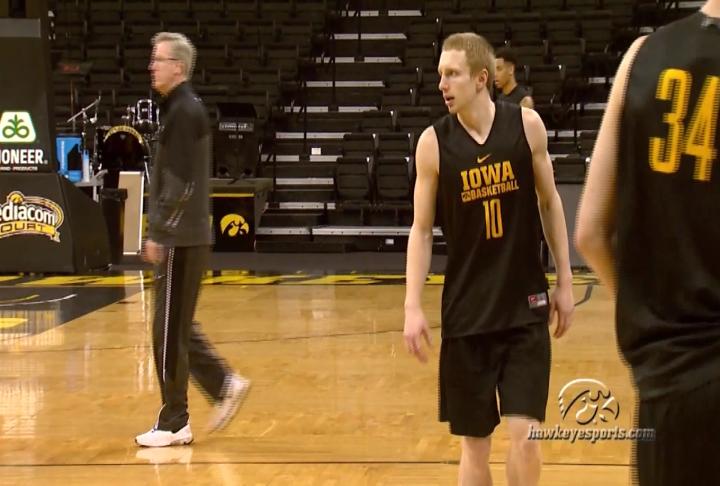 Mike Gesell practices in Iowa City as head coach Fran Mc Caffery looks