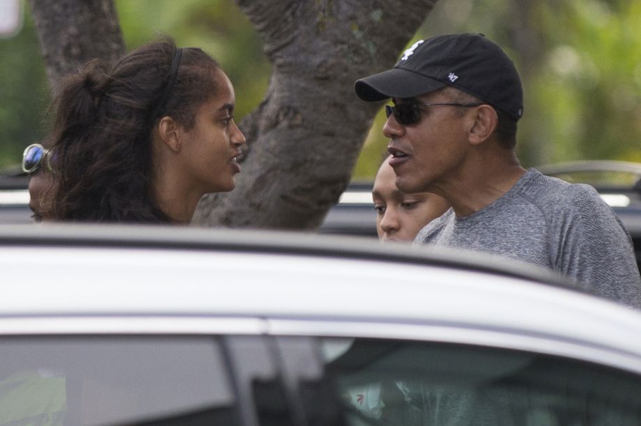 President Barack Obama right talks with his daughter Malia on a visit to Island Snow during a family vacation on Sunday Dec. 27 2015 in Kailua Hawaii