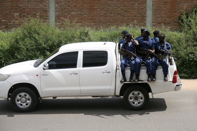 Military personnel sits aboard a vehicle driving through the Musaga neighbourhood of the city of Bujumbura