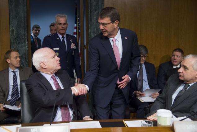 U.S. Secretary of Defense Ashton Carter shakes hands with Sen. John Mc Cain as he arrives to testify during a Senate Armed Services Commitee hearing on Wednesday