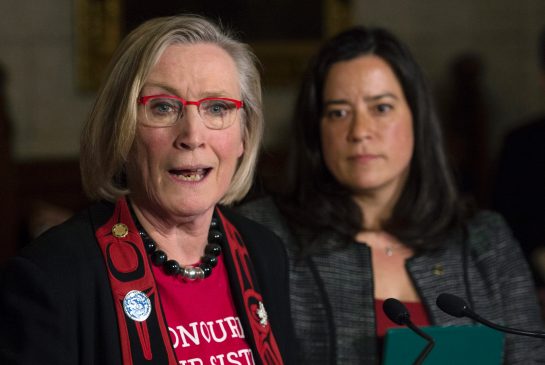 Minister of Justice and Attorney General of Canada Jody Wilson Raybould looks on as Minister of Indigenous and Northern Affairs Carolyn Bennett responds to a question during an announcement for a Missing and Murdered Indigenous Women inquiry on Parliament