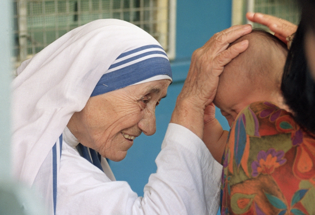 Mother Teresa gives her blessing to a child at the Gift of Love Home