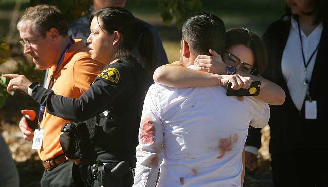 A couple embraces following a shooting that killed multiple people at a social services facility Wednesday Dec. 2 2015 in San Bernardino Calif.  MAGS OUT MANDATORY CREDIT LOS ANGELES TIMES OUT