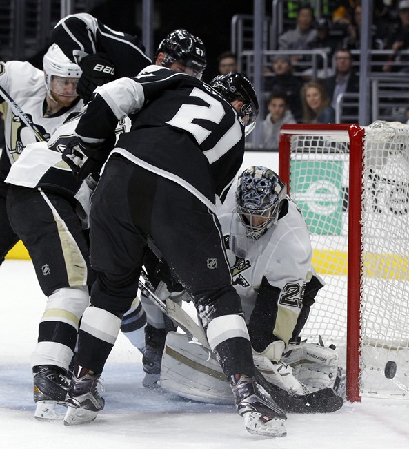 Pittsburgh Penguins goalie Marc Andre Fleury right blocks a shot by Los Angeles Kings center Nick Shore during the second period of an NHL hockey game in Los Angeles Saturday Dec. 5 2015