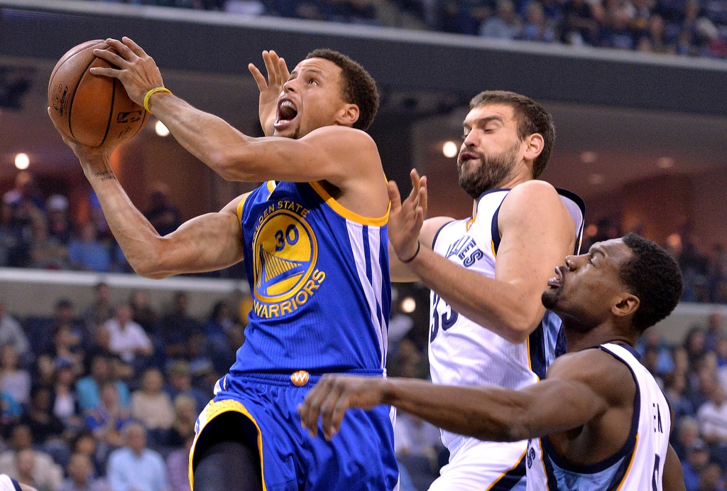 Golden State Warriors guard Stephen Curry shoots against Memphis Grizzlies center Marc Gasol center and guard Tony Allen in the first half of an NBA basketball game in Memphis Tenn. Curry has been named Th