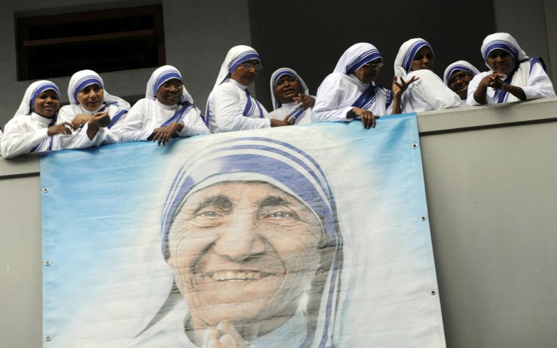 Nuns belonging to the Missionaries of Charity order follow the service to mark the 100th birth anniversary of Mother Teresa at her tomb in the Missionaries of Charity house in Kolkata