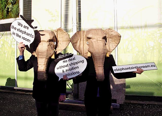 NGO representatives wear elephant masks and hold banners at the United Nations Climate Change Conference in Le Bourget north of Paris